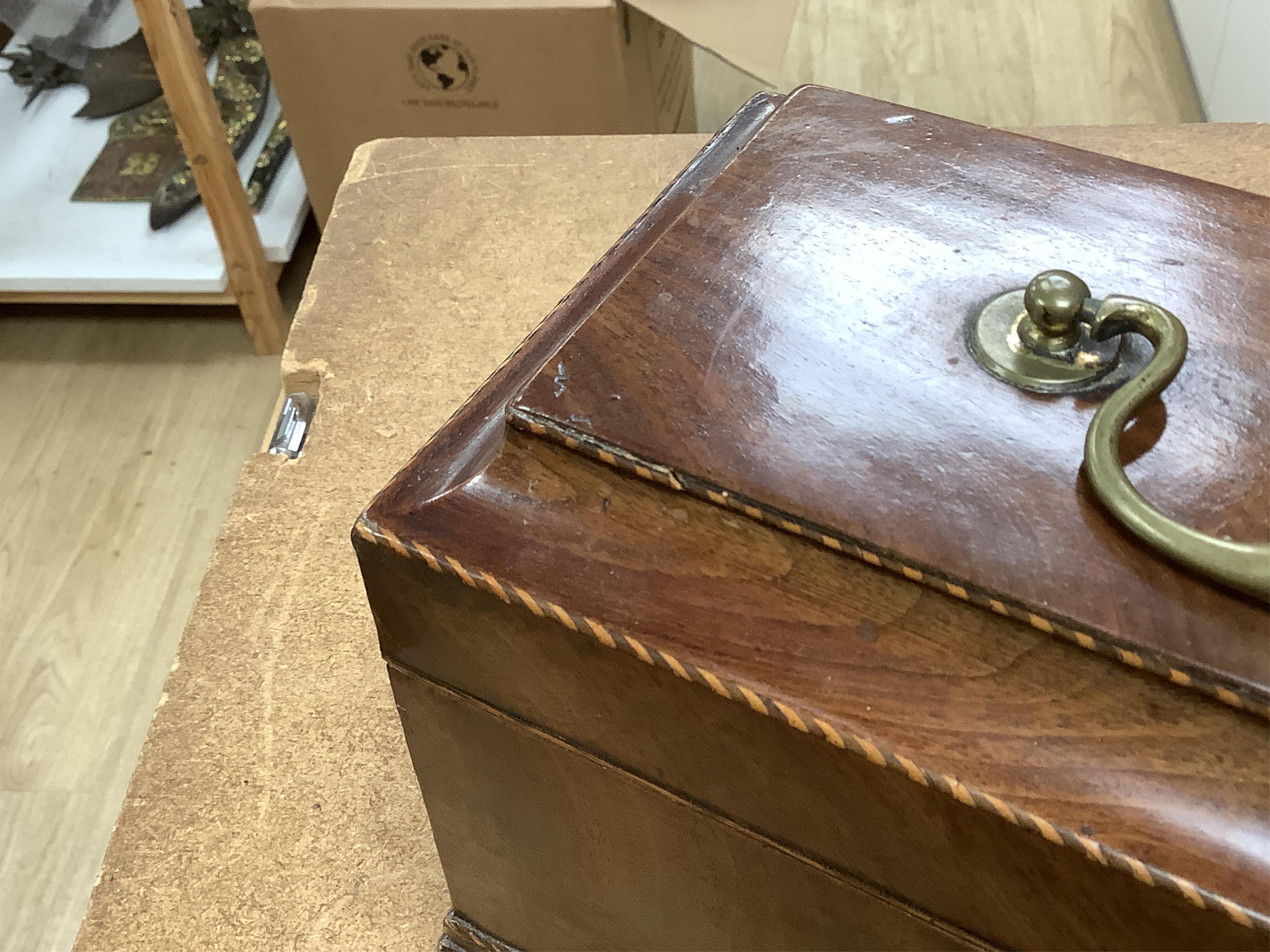 A George III mahogany tea caddy, containing tinned metal canisters, 25cm wide